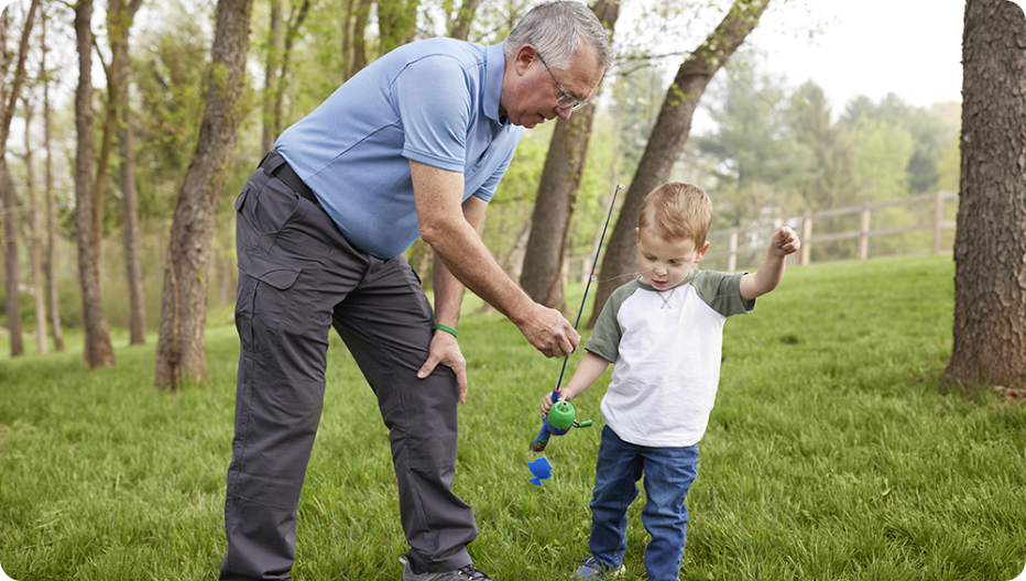 Roland and his grandfather outside with fishing pole