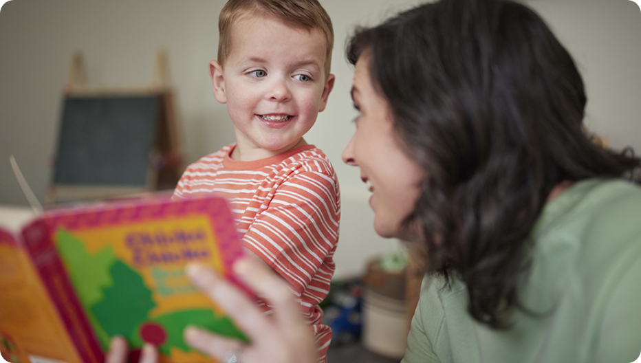 Roland with his mom reading a book