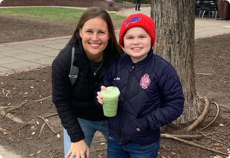 Jordan and his mom Laura smiling together outdoors